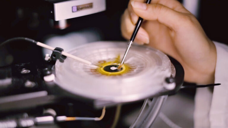 A researcher at the Allen Institute for Brain Science prepares a piece of live human brain tissue for electrical recording.