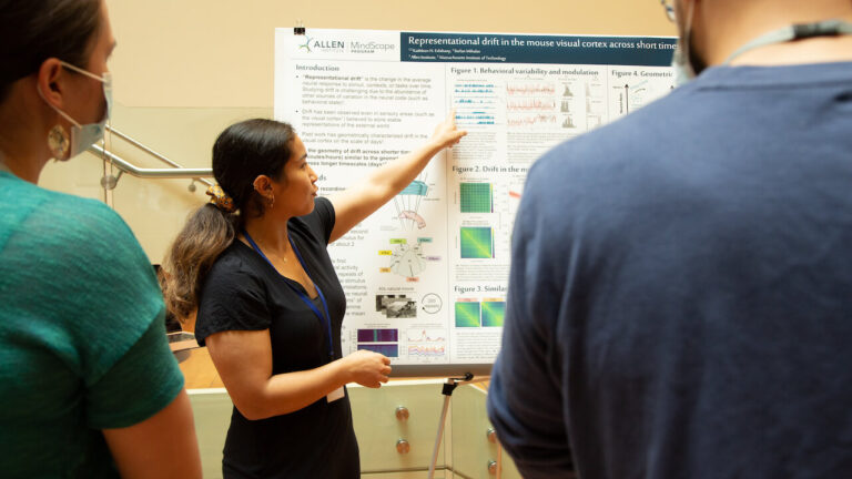 Kathleen Esfahany, an intern in the Allen Institute’s MindScope Program, presents her poster at the interns' final project presentation day. Esfahany's poster describes how the brain’s response to the same stimulus changes over time, also known as representational drift. Photo by Jenny Burns / Allen Institute