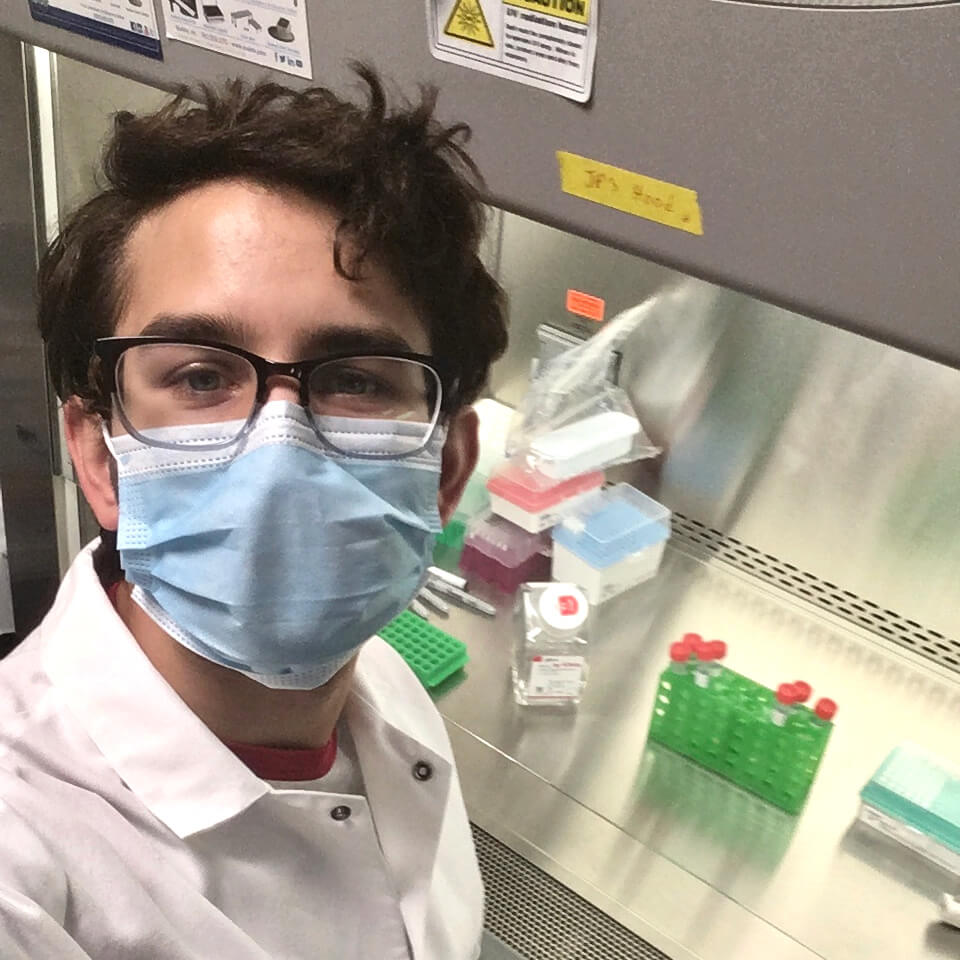 John Paul Thottam wears a mask while working in the lab at the Allen Institute.