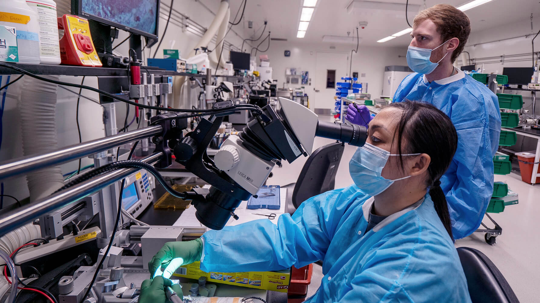 Allen Institute neuroscientist Katrina Nguyen prepares for OpenScope experiments as neuroscientist Conor Grasso observes.