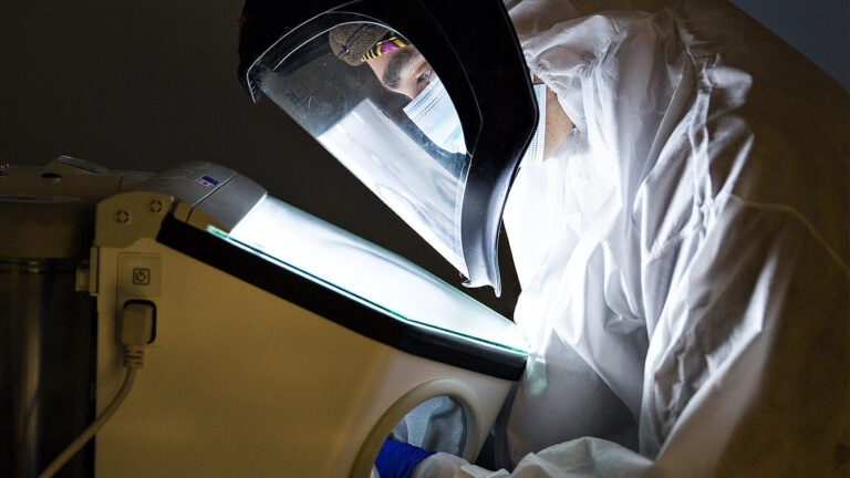 Researcher in protective suit