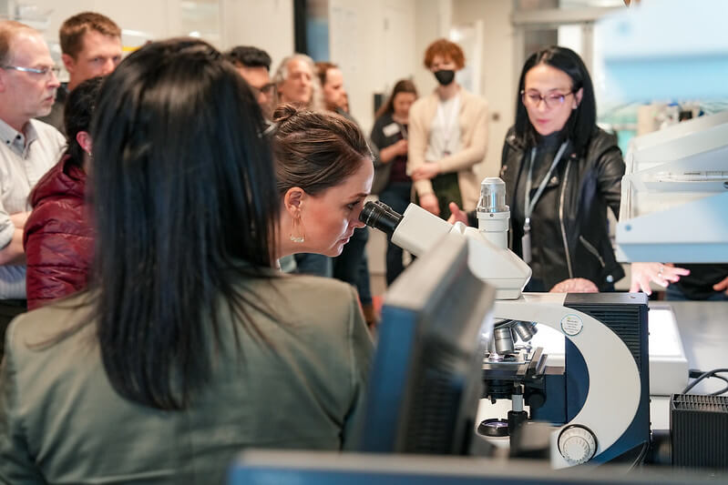 Teachers look into microscope at Allen Institute Education seminar