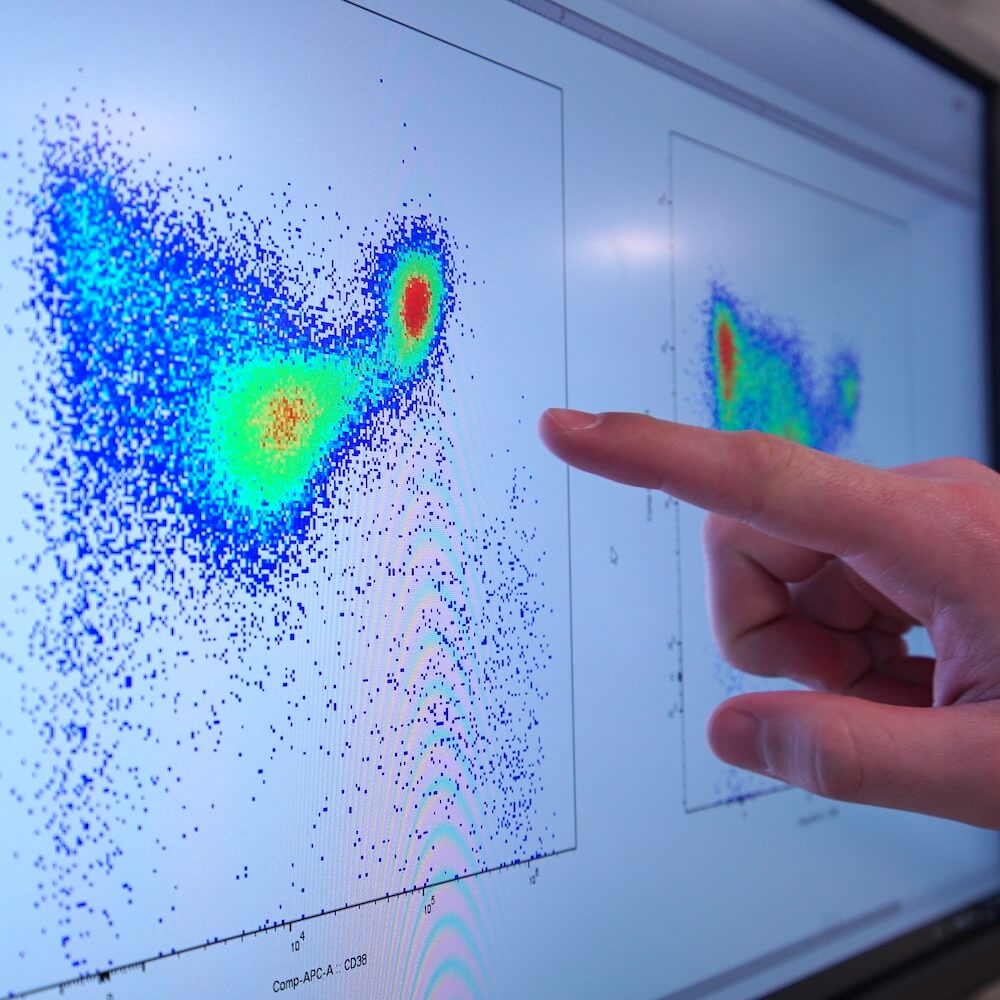 hand pointing to science data on a computer screen