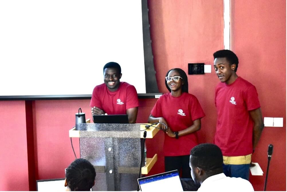 Three students presenting research