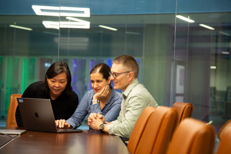 Three scientists looking over data at the Allen Institute.