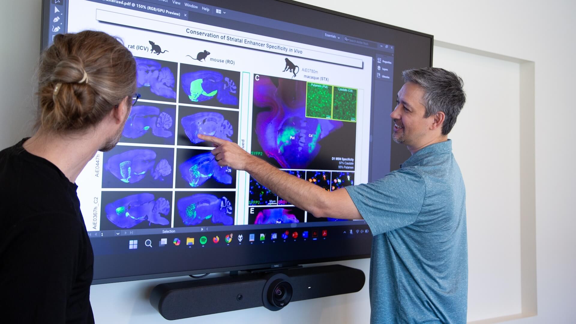 Allen Institute scientists Trygve Bakken, M.D., Ph.D., (left) and Jonathan Ting, Ph.D., (right) discuss research figures and data related to enhancer AAV tools. Photo by Jenny Burns / Allen Institute.