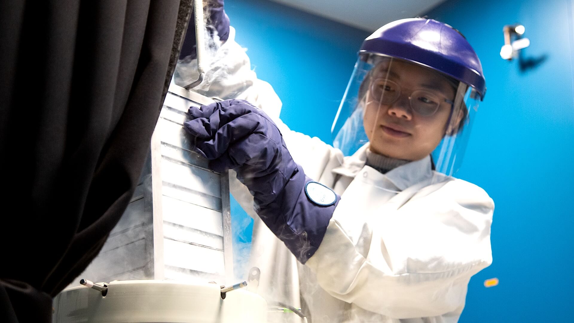 Researcher pulling out cells from liquid nitrogen storage for research
