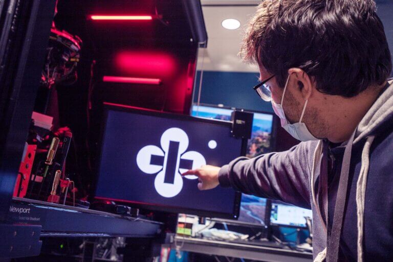 Scientist points at computer screen showing illusionary image.