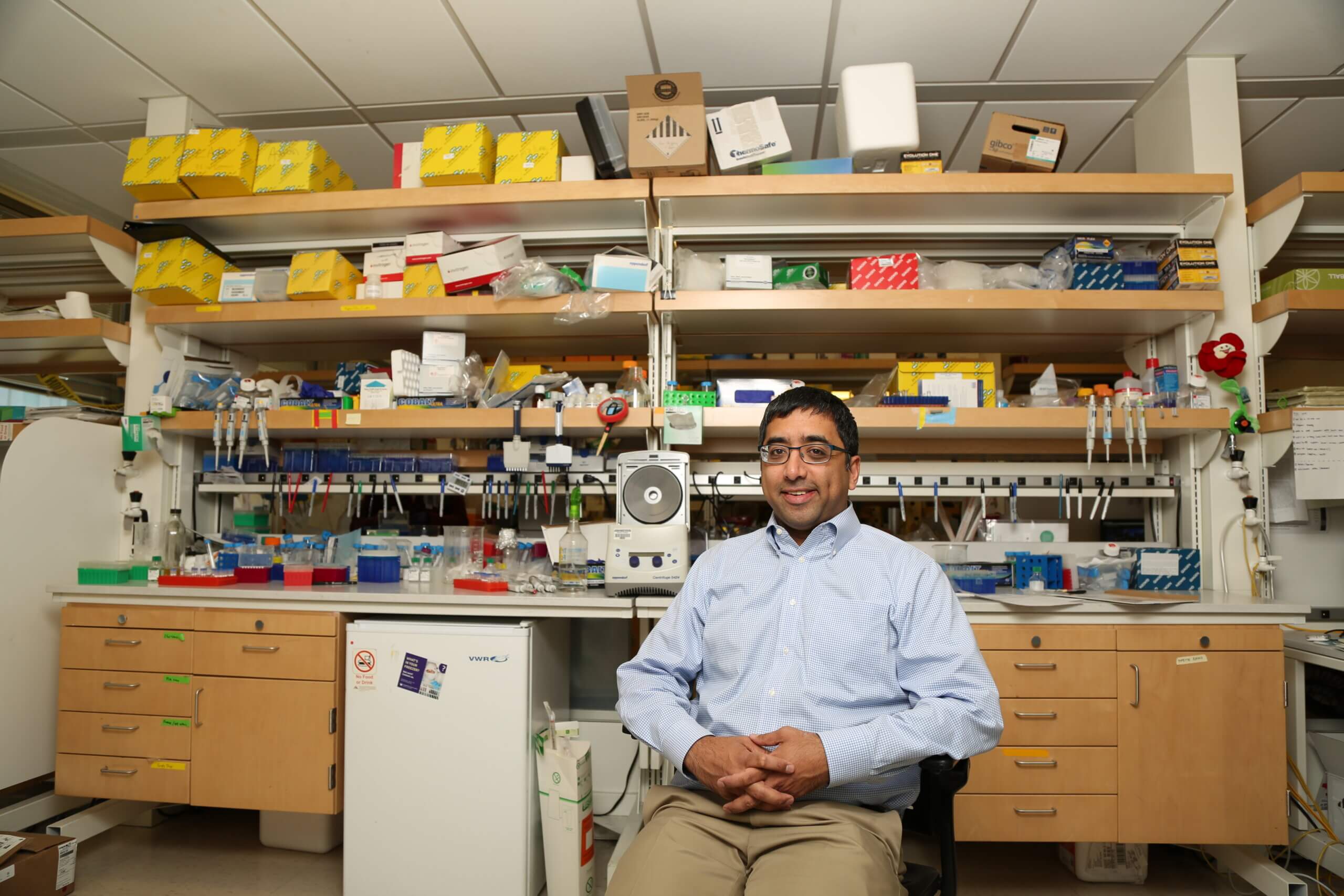 Jay Shendure seated on a chair inside his lab at the University of Washington