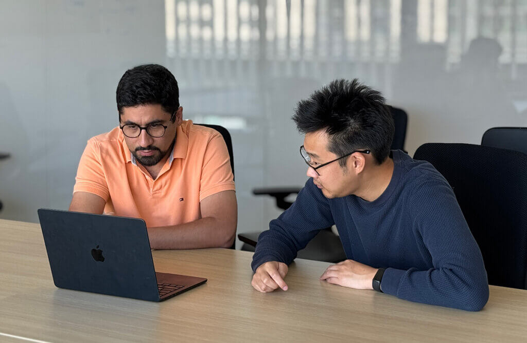 Two researchers at a laptop